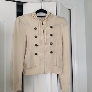 Cream zip-up hoodie; military inspired buttons